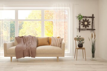 Stylish room in white color with sofa and autumn landscape in window. Scandinavian interior design. 3D illustration