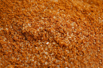 brown ground cinnamon mixed with sugar on the side view . aromatic spice for baking in cooking