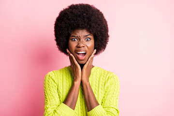 Photo portrait of upset woman touching face with two hands isolated on pastel pink colored background