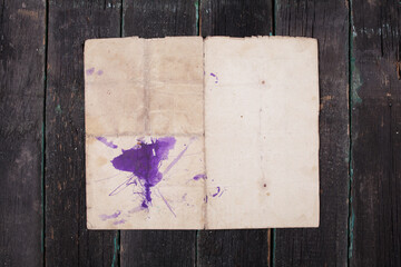 Sheet of old paper with a blot on an old wooden background. empty templates, mock-up.