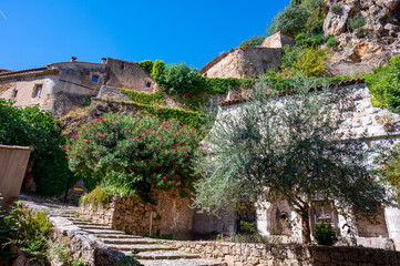 Fototapeta na wymiar Travel destination, small ancient village Cotignac in Provence, surrounded by vineyards and cliffs with troglodytes houses.