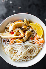 rice noodles Funchoza seafood cellophane pasta shrimp, mussels, squid preparing healthy meal snack top view copy space for text food background rustic
