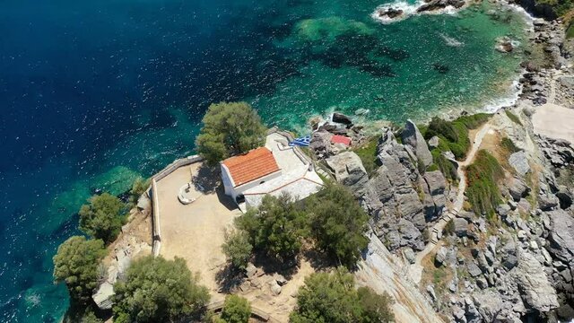Aerial drone video of picturesque chapel of Saint John built in famous cliff where Mamma Mia movie was filmed, Skopelos island, Sporades, Greece
