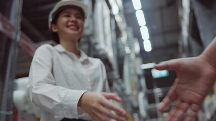 Handshake of engineer woman and business man Agree cooperation in working in the warehouse. Quality transportation service. Confidence in business leadership. Concept key worker