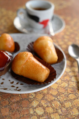 Classic italian espresso coffee served with homemade rum baba soft cake