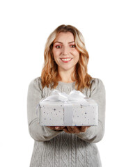 Smiling young woman holding out a present