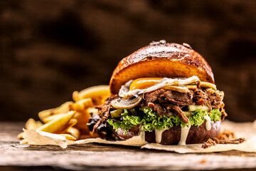 Burger stuffed with shredded confit turkey egg mushrooms and french fries
