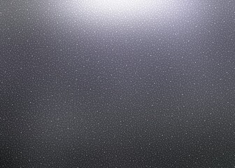 Fine dust shimmering in top light on dark grey background.
