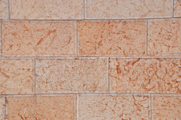 Background, texture - a plastered wall with joining for large bricks. Pink color