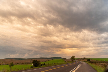 Highway in southern Brazil cutting fields in the Pampa biome at dusk