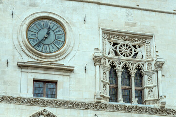 three-mullioned window and wall-clock at SS Annunziata church, Sulmona, Italy