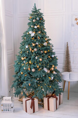 Decorated green Christmas tree in a light room