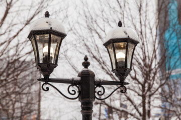 Fototapeta na wymiar street lamp, covered with a snow cap
