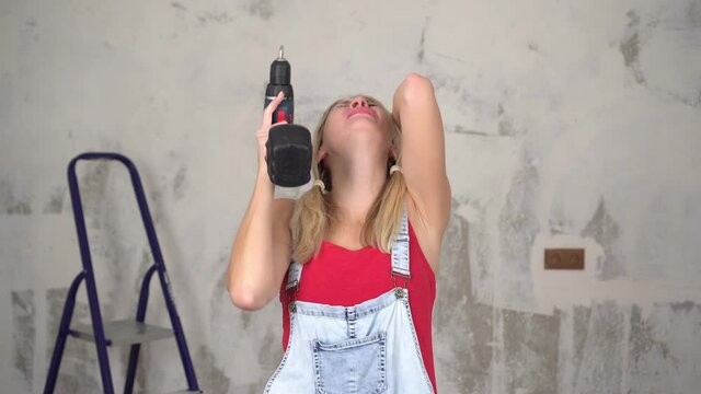 Emotional, tired, unhappy woman screams out of anger while renovating or building a house