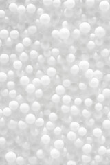 White balls background, soft pearl texture. Abstract snowy white winter backdrop, close-up.
