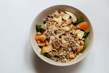 A mixed vegetable salad.Bowl of healthy vegetable salad isolated on white background, top view. Healthy food, vegetarian dieting.Salad with spinach.