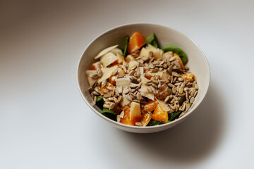 A mixed vegetable salad.Bowl of healthy vegetable salad isolated on white background, top view. Healthy food, vegetarian dieting.Salad with spinach.