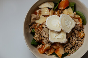 A mixed vegetable salad.Bowl of healthy vegetable salad isolated on white background, top view. Healthy food, vegetarian dieting.Salad with spinach.