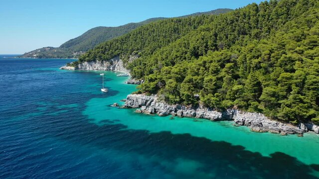Aerial drone video of breathtaking secluded turquoise beaches of Ftelia and Megalo Pefko in island of Skopelos, Sporades, Greece