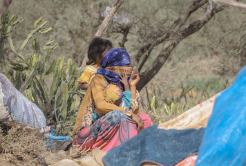 Yemeni women live in the open after being displaced from their homes due to the war in Taiz