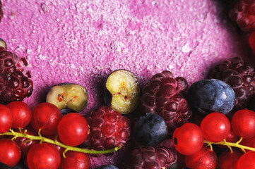 Festive cake, blueberry and blackberry sponge cake with cream cheese inside on a plate on a wooden table, horizontal view from above.Macro photo.