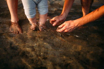 child and dad wash their feet in water, parenthood