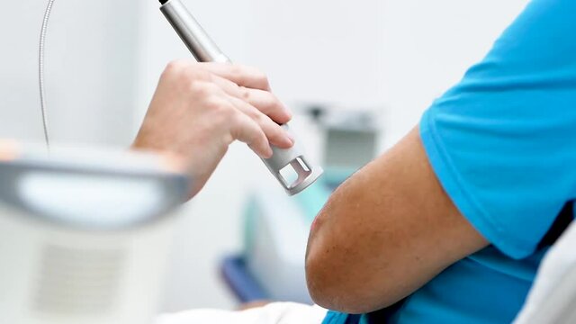 Crop therapist curing patient with laser probe