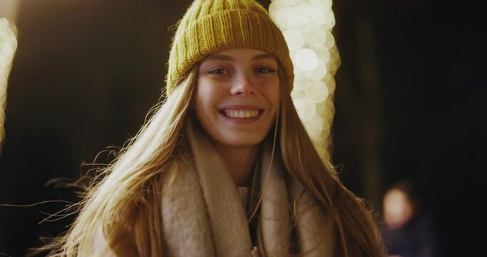 Portrait of happy caucasian pretty woman with long blonde hair wearing yellow hat laughing to camera smiling cheerfully outdoor.