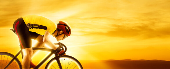 Man racing cyclist on sunset background. Man in yellow cycling jersey