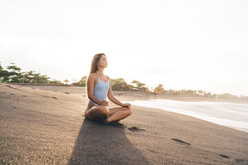 Fototapeta na wymiar Calm woman meditating on beach