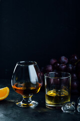 Whiskey and cognac in glasses on a dark background. copyspace