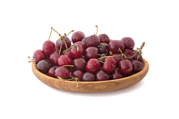 Ripe tasty cherries in the wood plate isolated on white