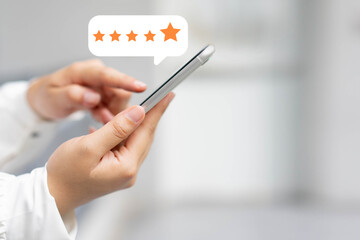 close up on customer woman hand pressing on smartphone screen with gold five star rating feedback icon and press level three rank (good) for give score point to review the service business concept	 - obrazy, fototapety, plakaty