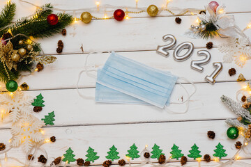 Medical mask on a white Christmas background. Christmas card for the new year 2021