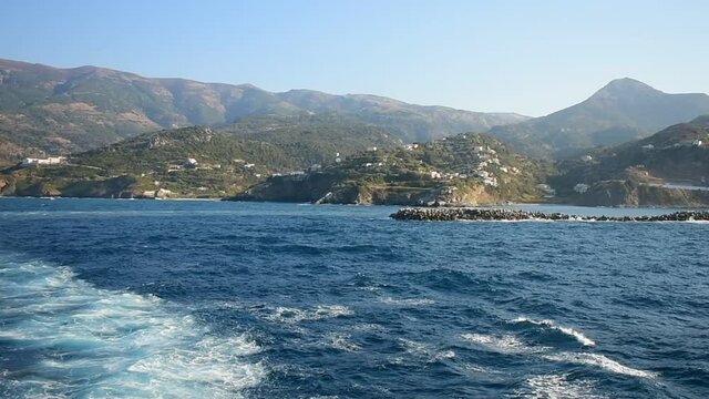 View from a boat leaving the island Ikaria in Greece. Travel concept.
