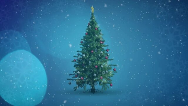 Animation of decorated christmas tree, snow falling and light spots
