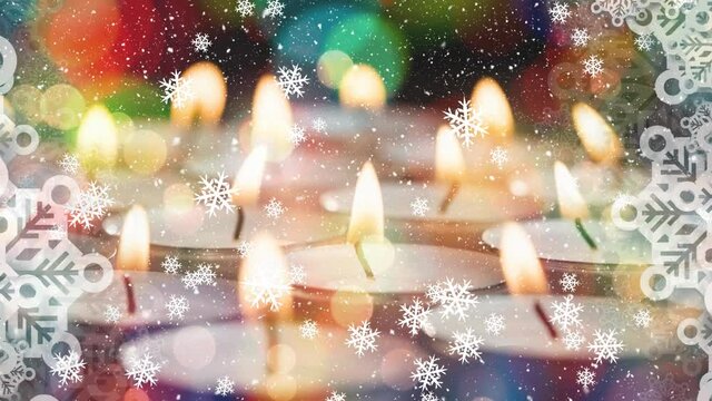 Animation of lit candles and christmas decorations with snow falling