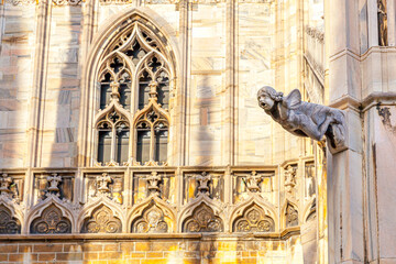 Roof of Milan Cathedral Duomo di Milano with Gothic spires and white marble statues. Top tourist...