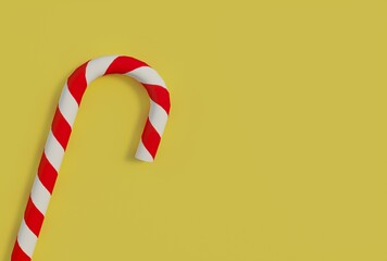 Candy stick close-up on yellow background with copy space. Christmas candy cane with white with red stripes. Christmas symbol. New year concept. 3D rendering