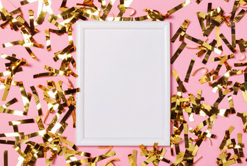 Naklejka na ściany i meble Celebration background with white frame and party gold confetti on pink background. Top view.