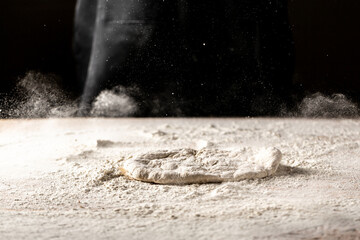 Flour dough sprinkled on a table with flour splash. Cooking bread. Kneading the Dough. banner, menu, recipe, place for text