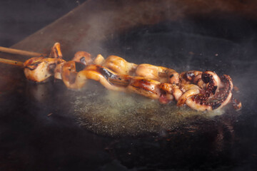 Cumi bakar or grilled squid is Indonesian street food. selective focus. grainy picture