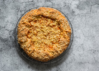 Caramelized pumpkin cinnamon crumble pie on a grey background, top view