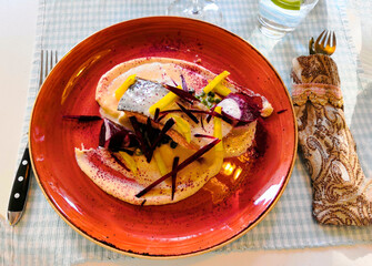 meat in white sauce with potatoes in a restaurant, beautiful table setting for lunch