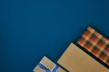 Fototapeta na wymiar Gift boxes on a blue background. Christmas and New Year's decor. Copy space, mock up.