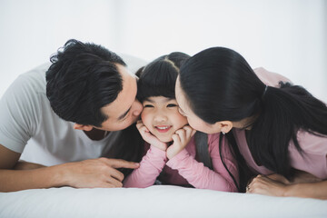 Happy family with little daughter having fun at home. Winter vacation concept