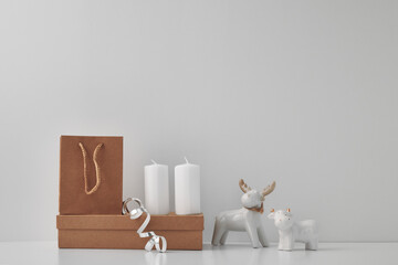 Porcelain figurine of a deer and a bull and New Year's, festive decor. Copy space, mock up.