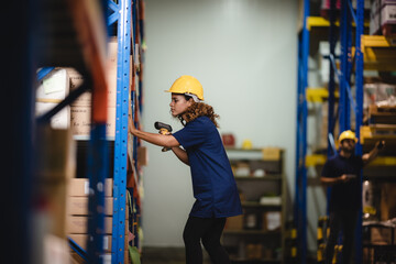 warehouse worker using bar code scanner to analyze newly arrived goods for further placement in...