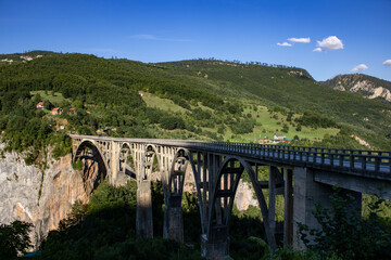 Fototapeta na wymiar Djurdzhevich Bridge over the Tara River canyon. Picturesque mountain landscape of Durmitor National Park, Montenegro, Europe, Balkans, Dinaric Alps, UNESCO World Heritage Site