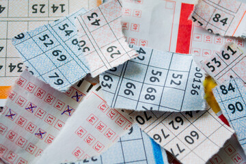 Torn lottery tickets with numbers. The concept of losing money and luck